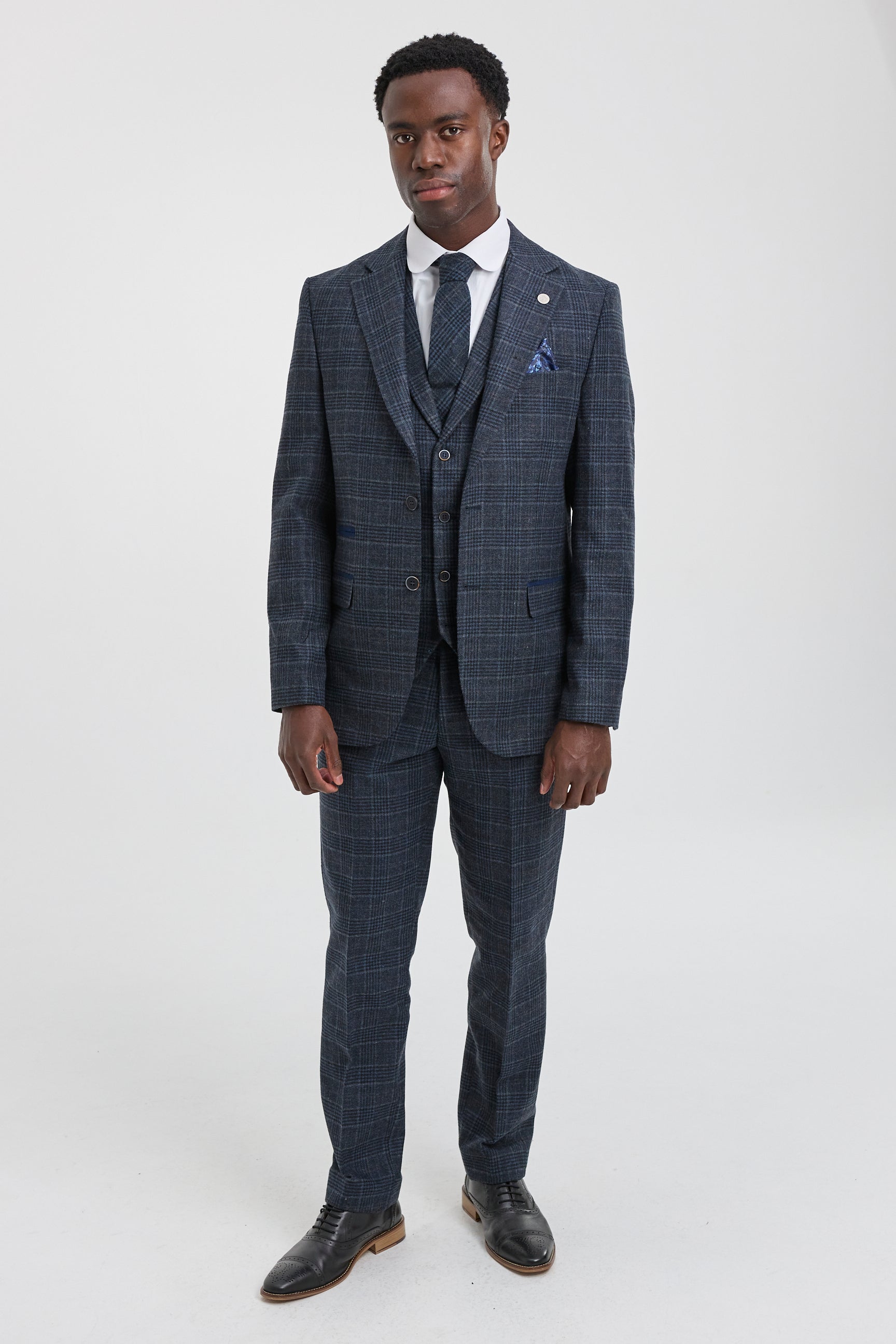 Traje de tres piezas para hombre con estampado de cuadros escoceses azules.