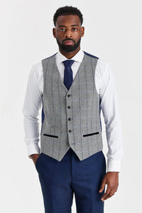 Traje azul marino Arthur con chaleco de tweed gris Harris en contraste.
