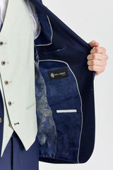 Traje azul marino Belmont con chaleco Belmont color verde salvia en contraste.