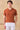 Polo de punto acanalado color naranja óxido para hombre