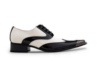 Zapatos de charol para hombre en blanco y negro con puntera metálica.