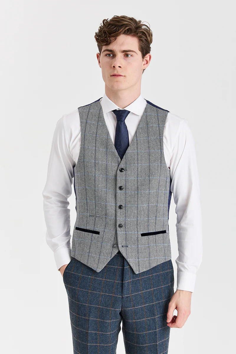 Traje de tweed azul marino de Harris con chaleco de tweed gris de Harris en contraste.