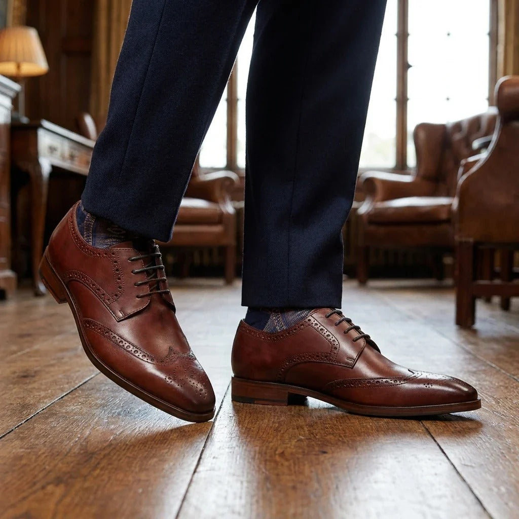 Zapatos de hombre de cuero burdeos, estilo clásico formal, con cordones y diseño brogue.