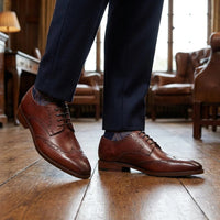 Zapatos de hombre de cuero burdeos, estilo clásico formal, con cordones y diseño brogue.